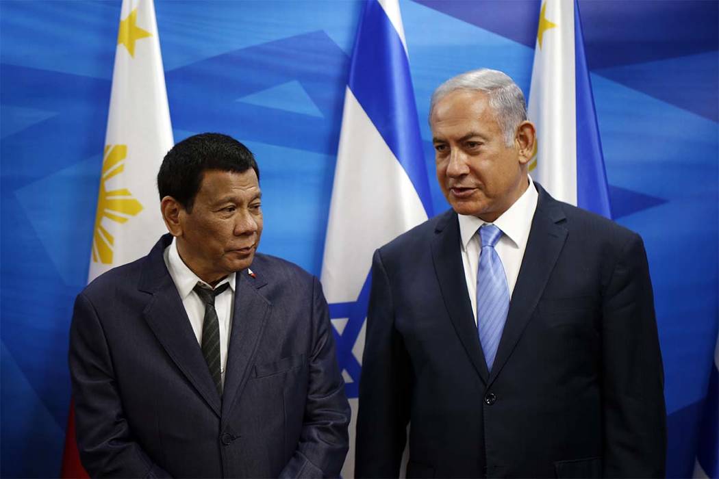 Israeli Prime Minister Benjamin Netanyahu, right, stands next to Philippine President Rodrigo D ...