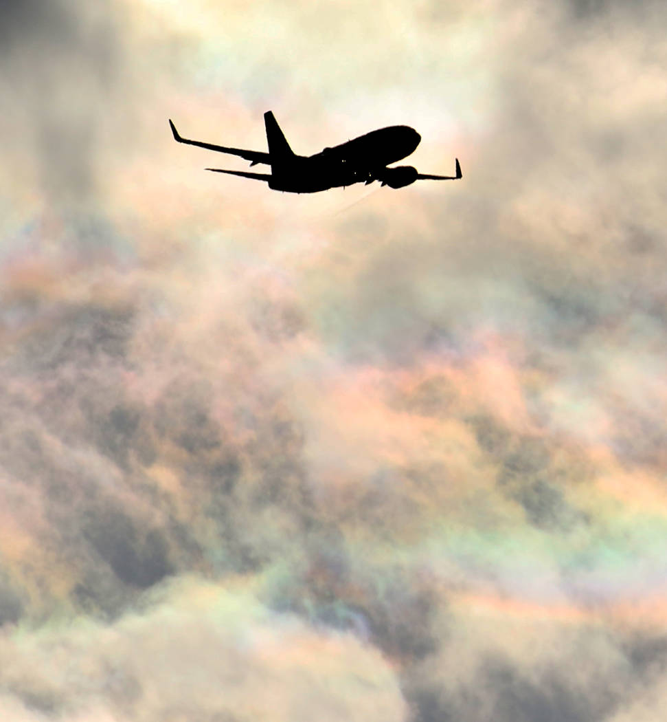 A Southwest Airlines plane flies under rainbow sky as it approaches McCarran International Airp ...