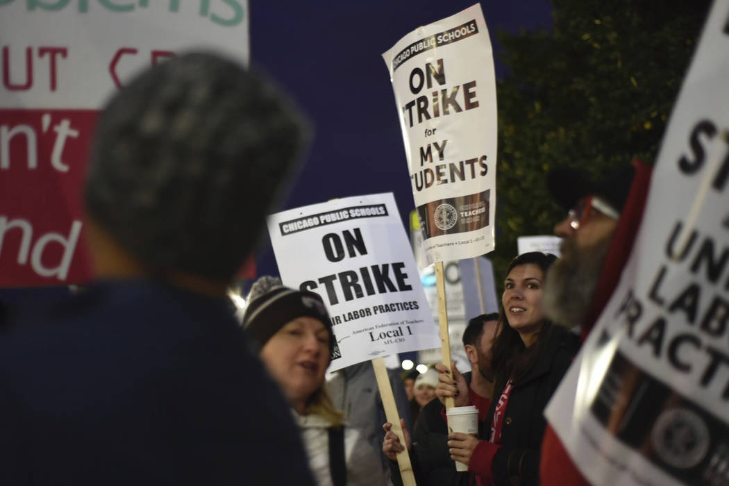 Chicago Public Schools teachers picket early Thursday morning, Oct. 17, 2019, at Lane Tech High ...