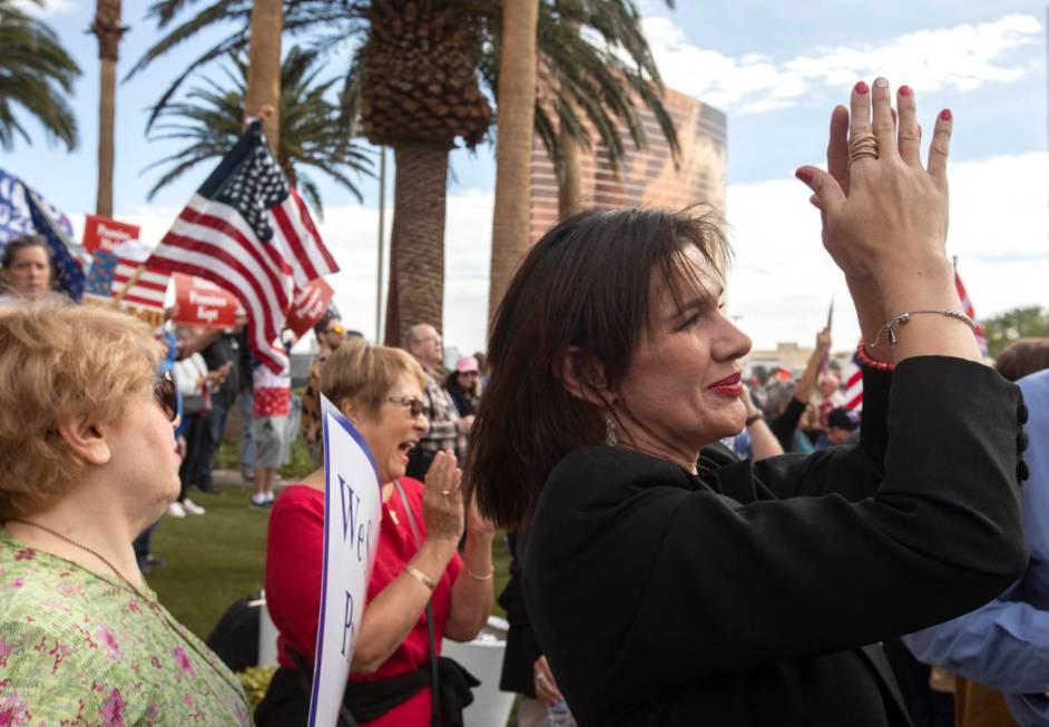 Ryon Urso of Southern Highlands claps for honking vehicles outside Trump International Hotel at ...