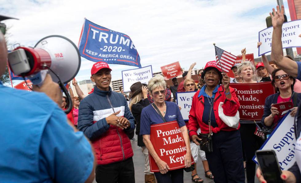 Trump supporters chant as they wait for the crosswalk to turn on Thursday, Oct. 17, 2019, in La ...