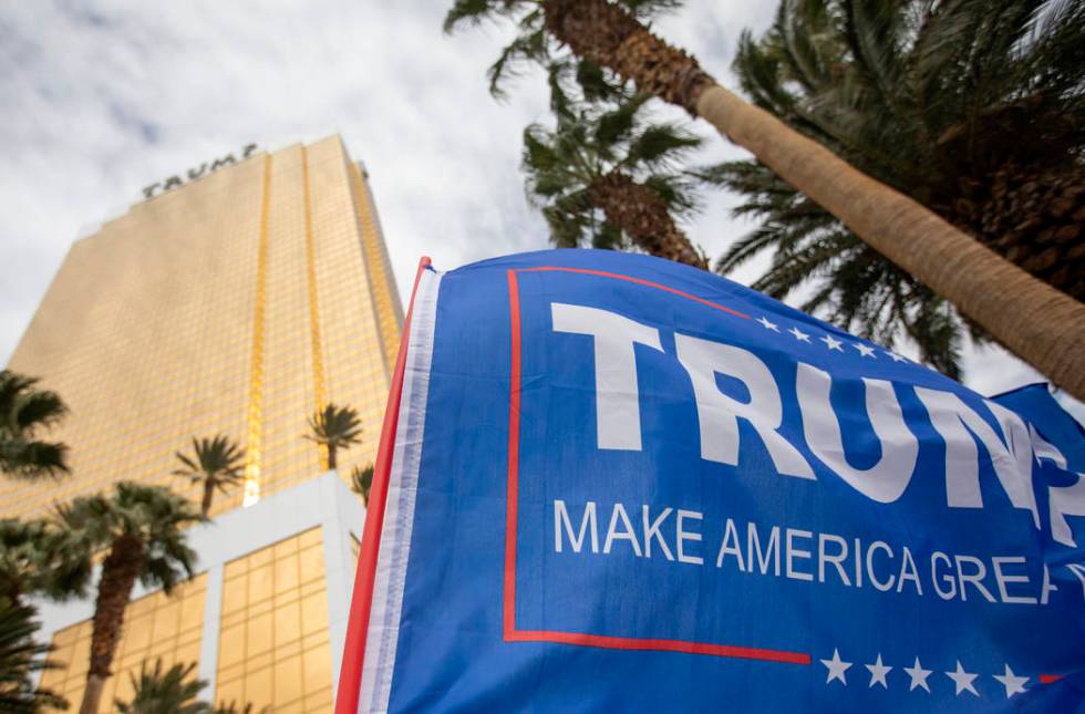 Trump merchandise, including flags, is displayed by supporters at the March for Trump on Thursd ...