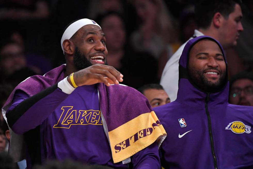 Los Angeles Lakers forward LeBron James, left, jokes around with center DeMarcus Cousins on the ...