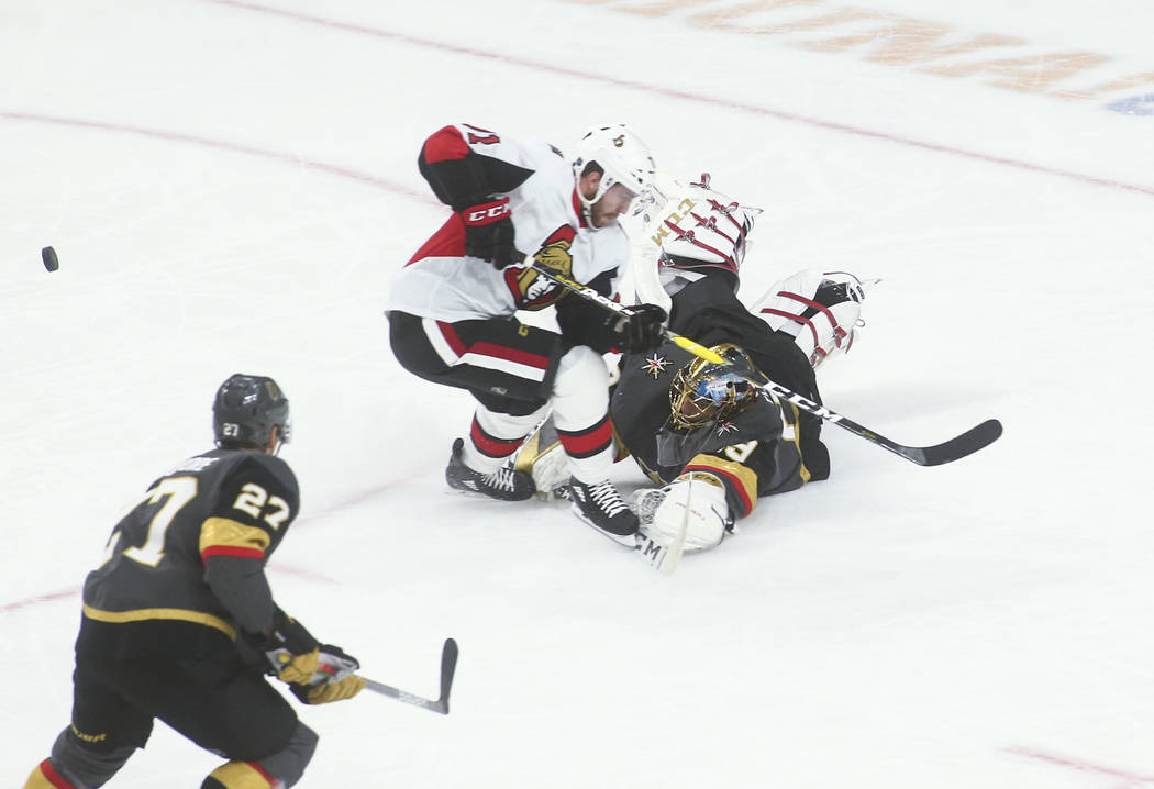 Golden Knights' Marc-Andre Fleury (29) blocks the puck against Ottawa Senators' Chris Tierney ( ...