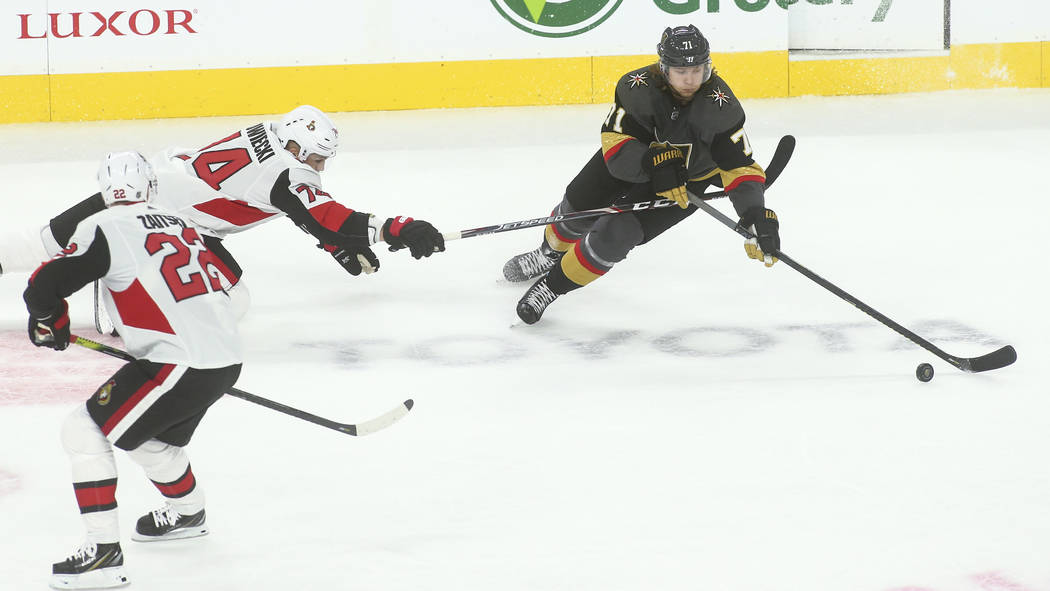 Golden Knights' William Karlsson (71) moves the puck under pressure from Ottawa Senators' Mark ...