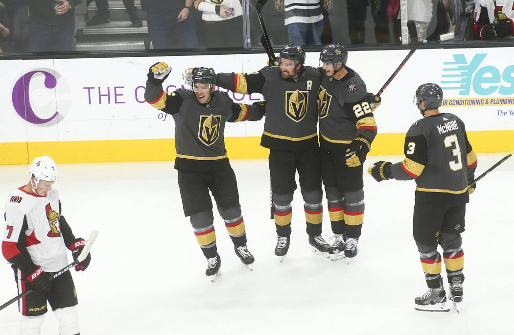 Golden Knights' Nick Holden, third from left, celebrates his goal with, from left, Paul Stastny ...