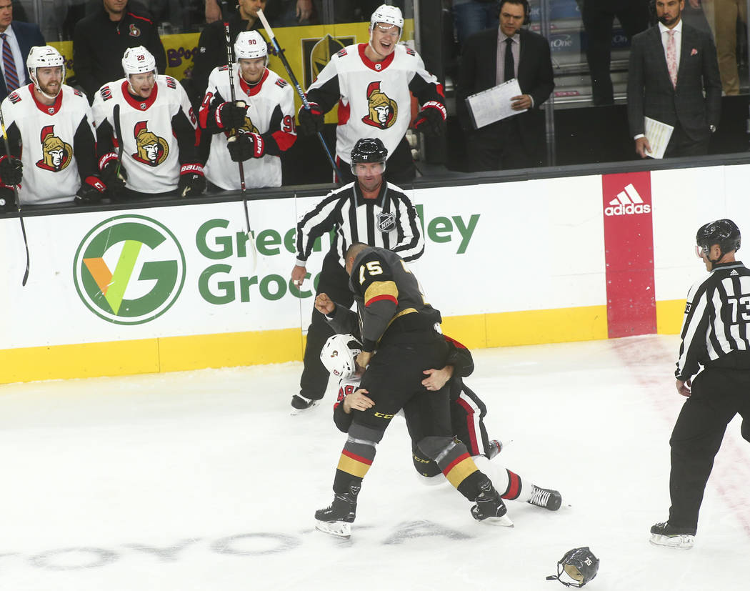 Golden Knights' Ryan Reaves (75) fights Ottawa Senators' Scott Sabourin (49) during the first p ...