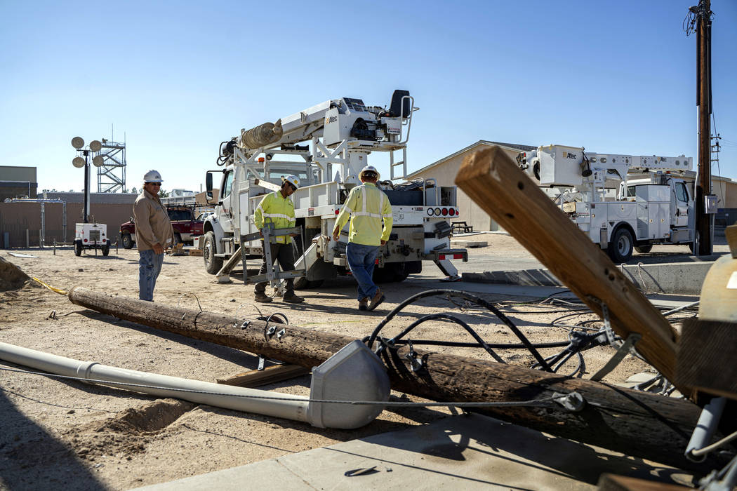 In this July 10, 2019 file photo provided by the U.S. Navy, civilian workers assigned to Naval ...