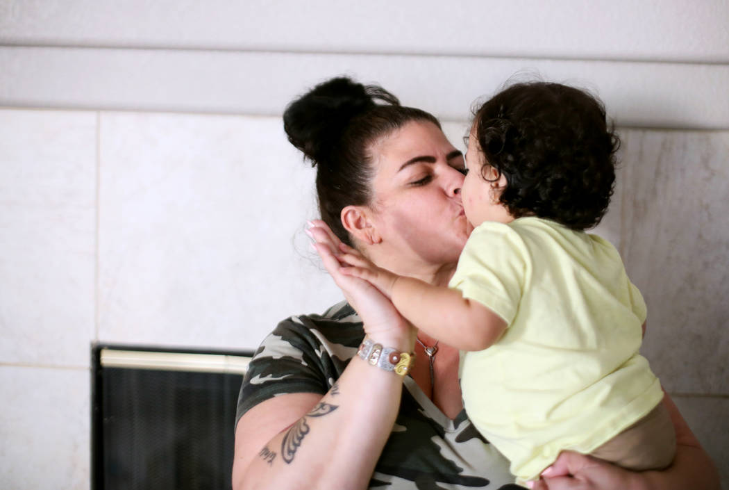 Hanna Olivas kisses her grandchild Damian Cordova, 1, at her home in Las Vegas, Wednesday, Oct. ...