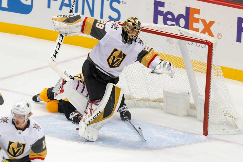 Vegas Golden Knights goaltender Marc-Andre Fleury (29) twists out of the way as Pittsburgh Peng ...