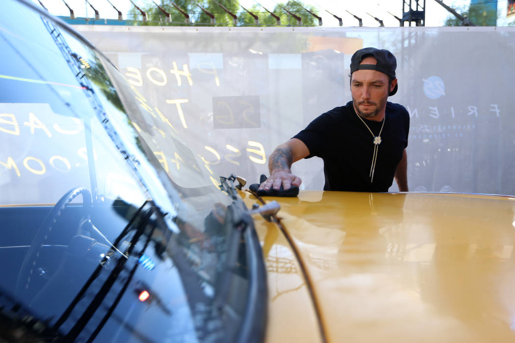 Art director Charlie Schwab gets a 1981 checkered marathon cab ready for Phoebe's Yellow Cab Es ...