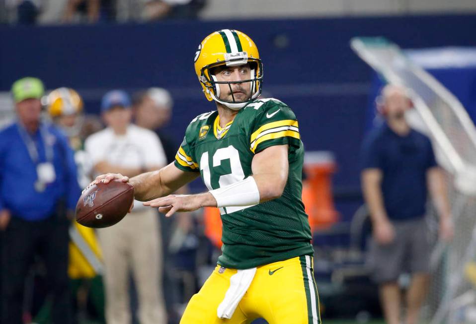 Green Bay Packers quarterback Aaron Rodgers (12) prepares to throw a pass during an NFL footbal ...