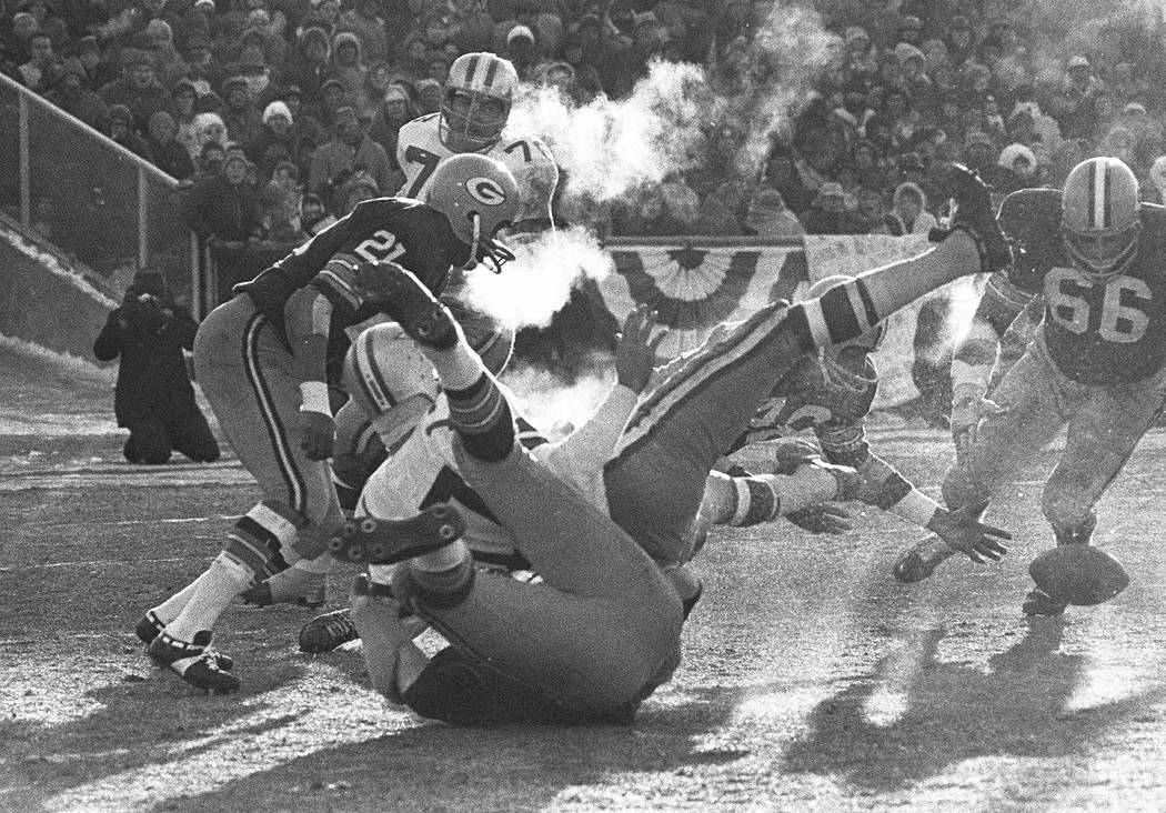 FILE - In this Dec. 31, 1967, file photo, players spill in all directions as a fumble occurs in ...