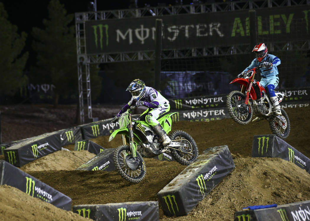 Eli Tomac (1) rides past Vince Friese (64) during the first round of the Monster Energy Cup Sup ...