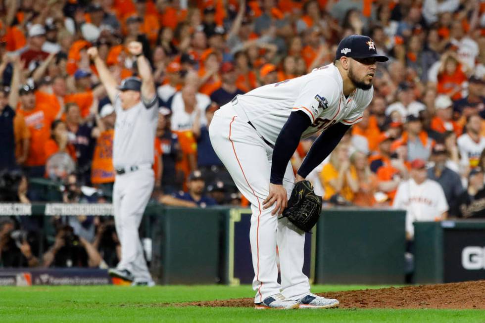 Houston Astros relief pitcher Roberto Osuna reacts after giving up a two-run home run to New Yo ...