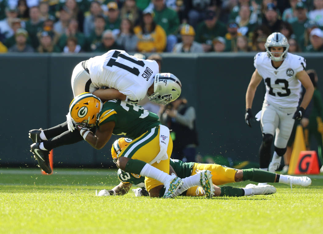 Oakland Raiders wide receiver Trevor Davis (11) tries to leap over Green Bay Packers strong saf ...