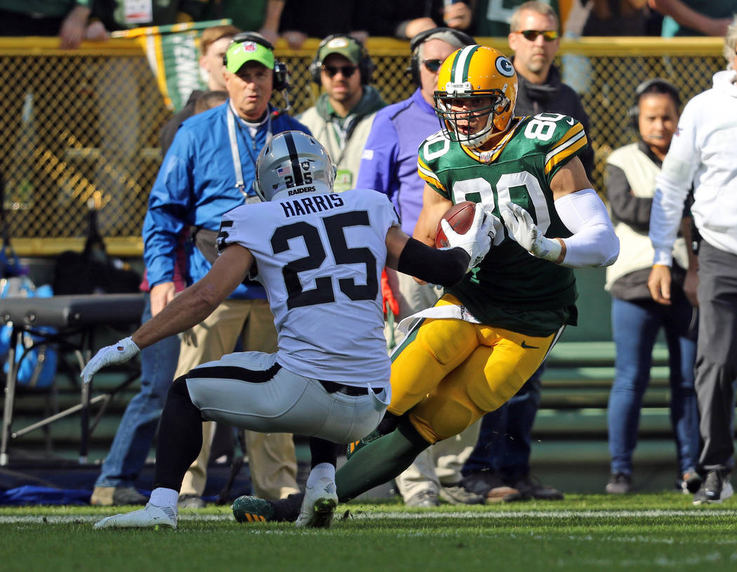 Green Bay Packers tight end Jimmy Graham (80) tries to run past Oakland Raiders free safety Eri ...