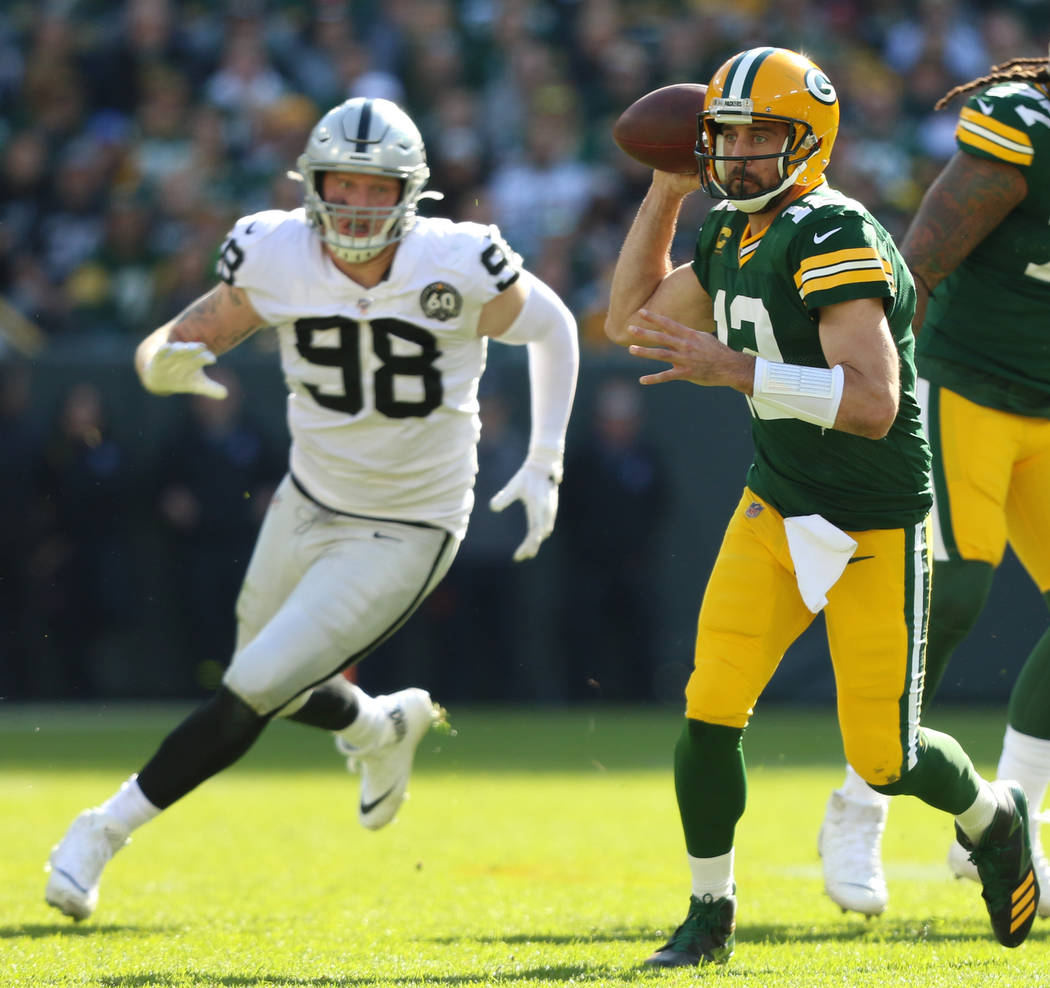 Green Bay Packers quarterback Aaron Rodgers (12) prepares to throw the football as Oakland Raid ...