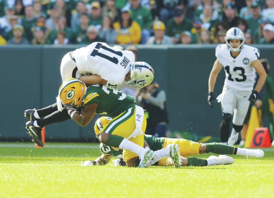 Oakland Raiders wide receiver Trevor Davis (11) tries to leap over Green Bay Packers strong saf ...