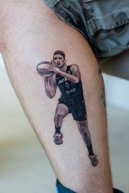 Local sports fan Trevor La Porte shows his recent tattoo of Las Vegas Aces player Dearica Hamby ...