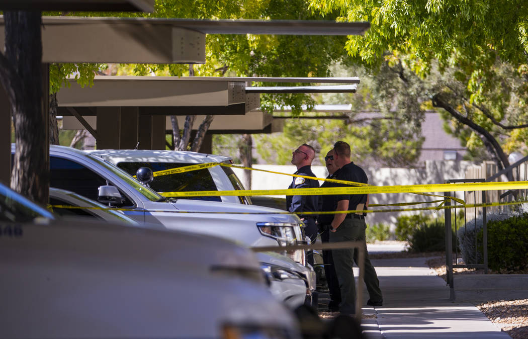 Officers work the scene of an officer-involved shooting at The Equestrian on Eastern Apartments ...