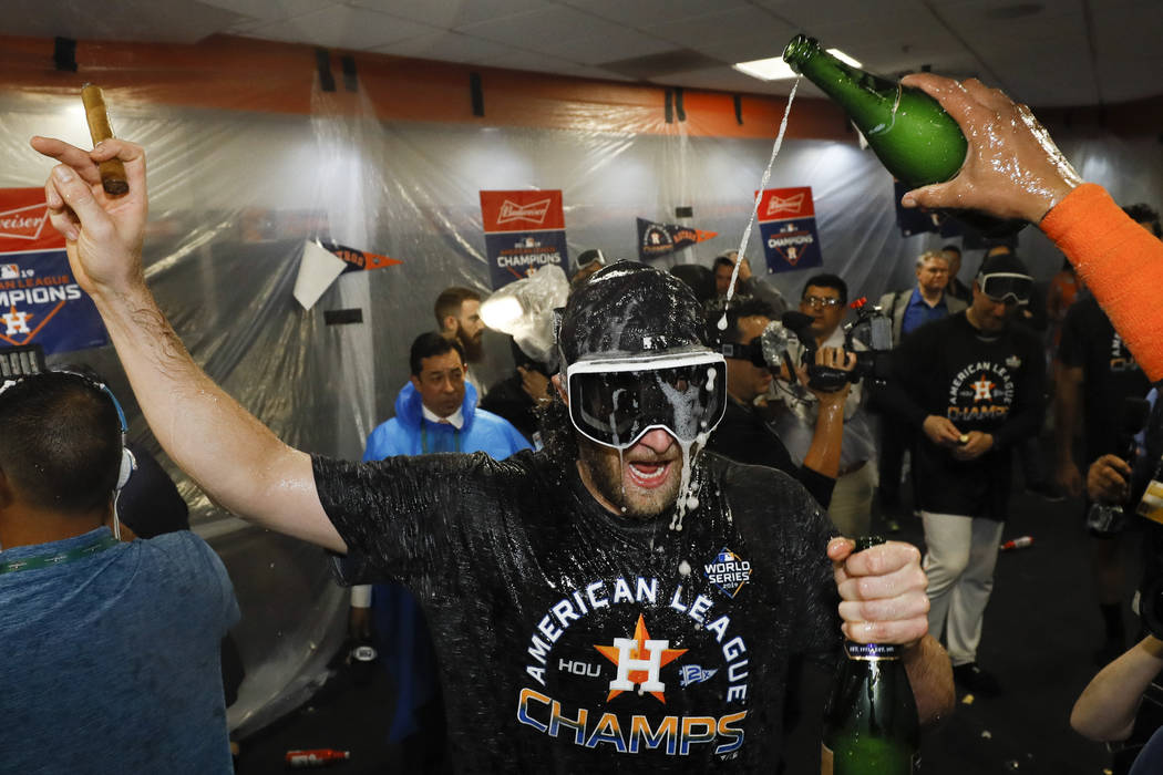 Houston Astros starting pitcher Gerrit Cole celebrates in the locker room after Game 6 of baseb ...