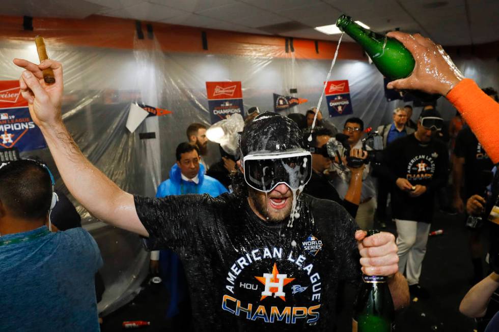 Houston Astros starting pitcher Gerrit Cole celebrates in the locker room after Game 6 of baseb ...