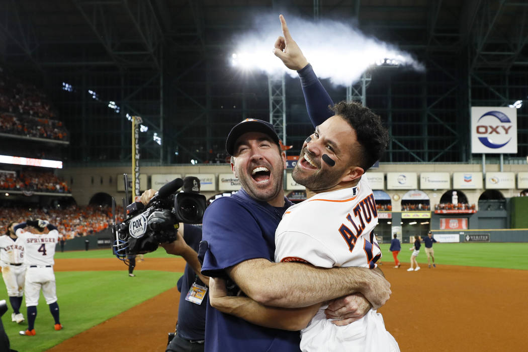 Houston Astros' Jose Altuve, right, and starting pitcher Justin Verlander celebrate after winni ...