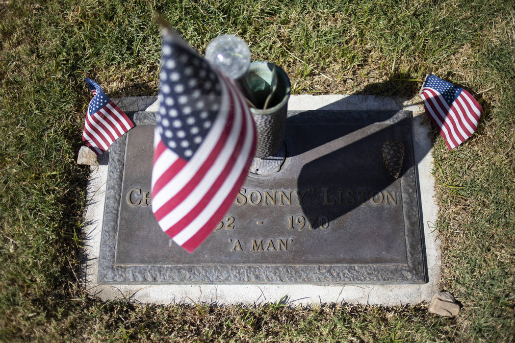 The grave of Sonny Liston, an American boxer, is adorned with flags and a small boxing glove ke ...