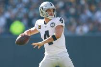 Oakland Raiders quarterback Derek Carr looks to pass during an NFL football game between the Gr ...