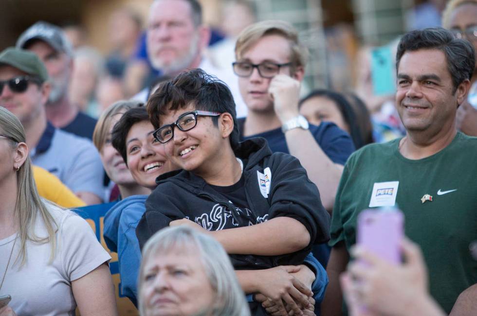 Dia Andreo, left, hugs Eli Serrato as Pete Buttigieg addresses them directly because of their y ...