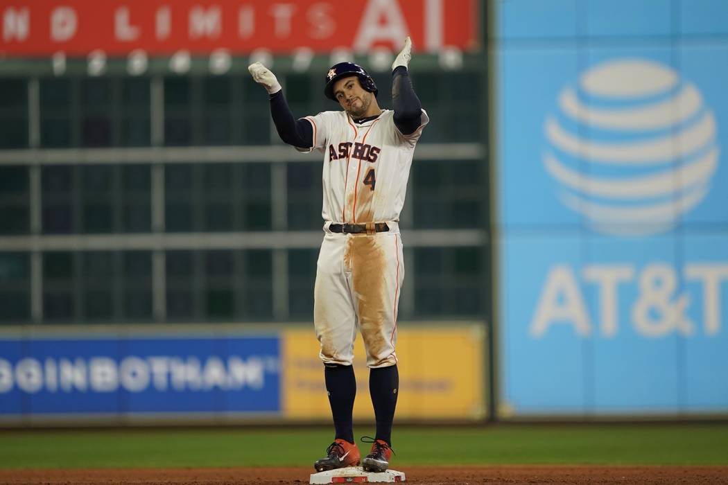 Houston Astros' George Springer reacts after hitting an RBI double during the eighth inning of ...
