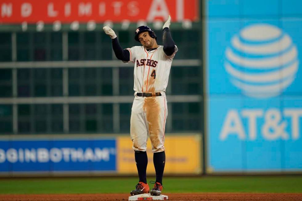 Houston Astros' George Springer reacts after hitting an RBI double during the eighth inning of ...