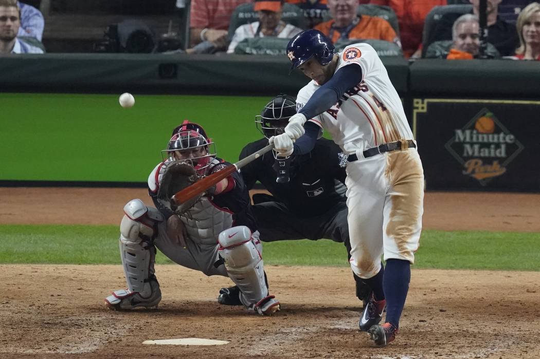 Houston Astros' George Springer hits an RBI double during the eighth inning of Game 1 of the ba ...