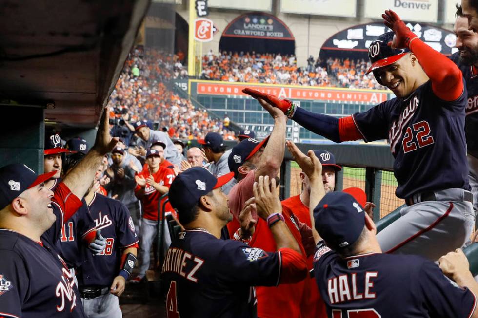 Washington Nationals' Juan Soto celebrates in the dugout after his home run against the Houston ...