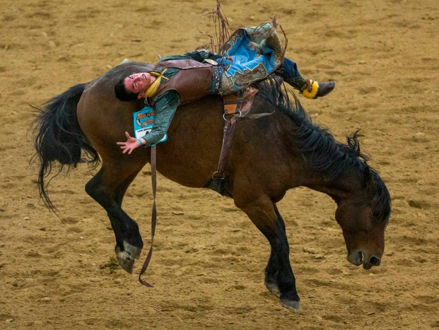 Bareback rider Earl Tsosie Jr. leans way back on his horse during the first round of the Indian ...