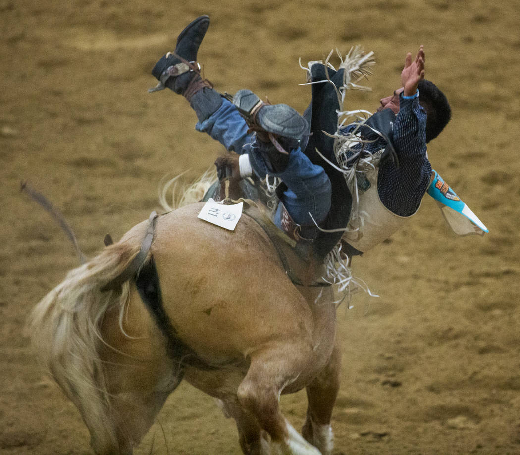 Bareback rider Delvecchio Kay ends up sideways on his horse during the first round of the India ...