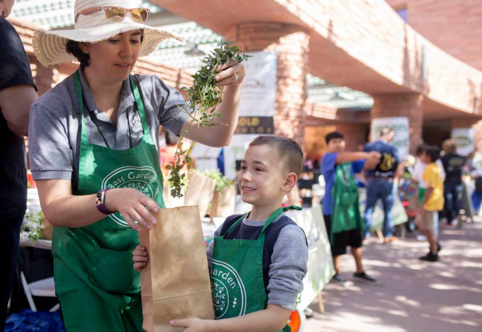 John C. Bass Elementary teacher Marin Mitchell, left, and her son Micah Mitchell, 6, bag fresh ...