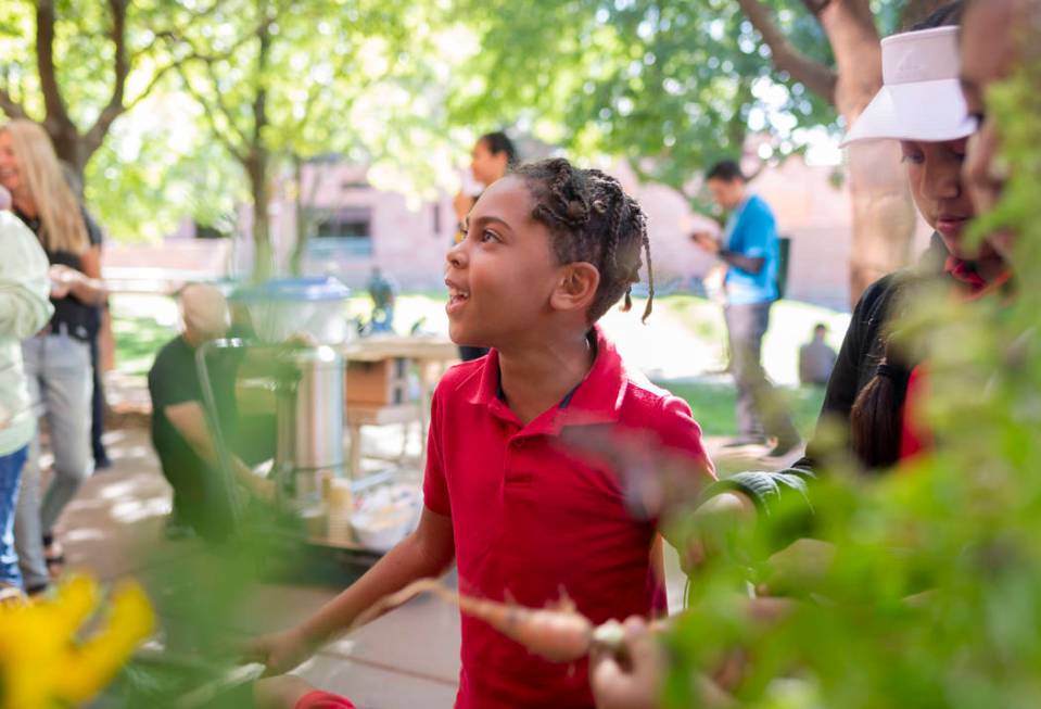 Rex Bell Elementary student Bradley Alveraz, 8, helps clean their garden club grown carrots to ...