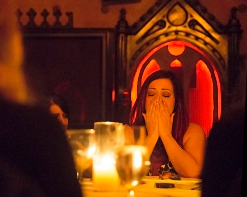 Rebecca Love reacts to a reading by psychic medium Thomas John during Dinner with the Dead on F ...