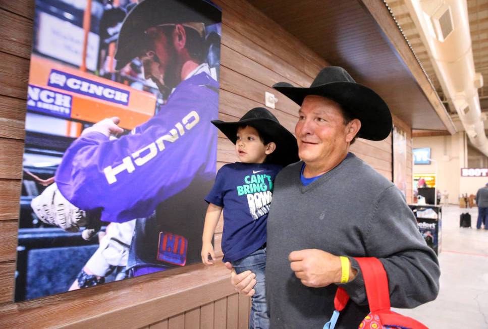 Mike Not Afraid and his grandson, Grayson Spotted Bear, 2, walk to the arena during Indian Nati ...