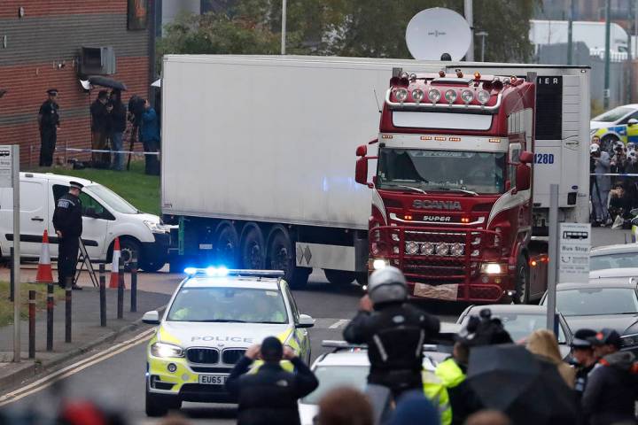 Police escort the truck, that was found to contain a large number of dead bodies, as they move ...