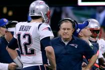 New England Patriots' Tom Brady, left, talks with head coach Bill Belichick during the first ha ...