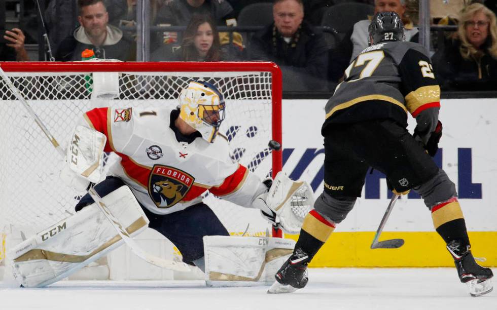 Vegas Golden Knights defenseman Shea Theodore (27) scores on Florida Panthers goaltender Robert ...