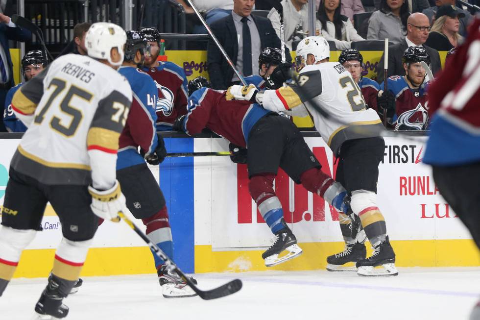 Vegas Golden Knights left wing William Carrier (28) pushes Colorado Avalanche left wing Matt Ca ...