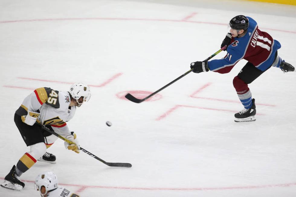 Colorado Avalanche left wing Matt Calvert (11) shoots for a score under pressure from Vegas Gol ...