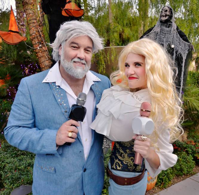 David Tolliver, as Kenny Rogers, and Jenna Pate, as Dolly Parton, are shown on Halloween night ...