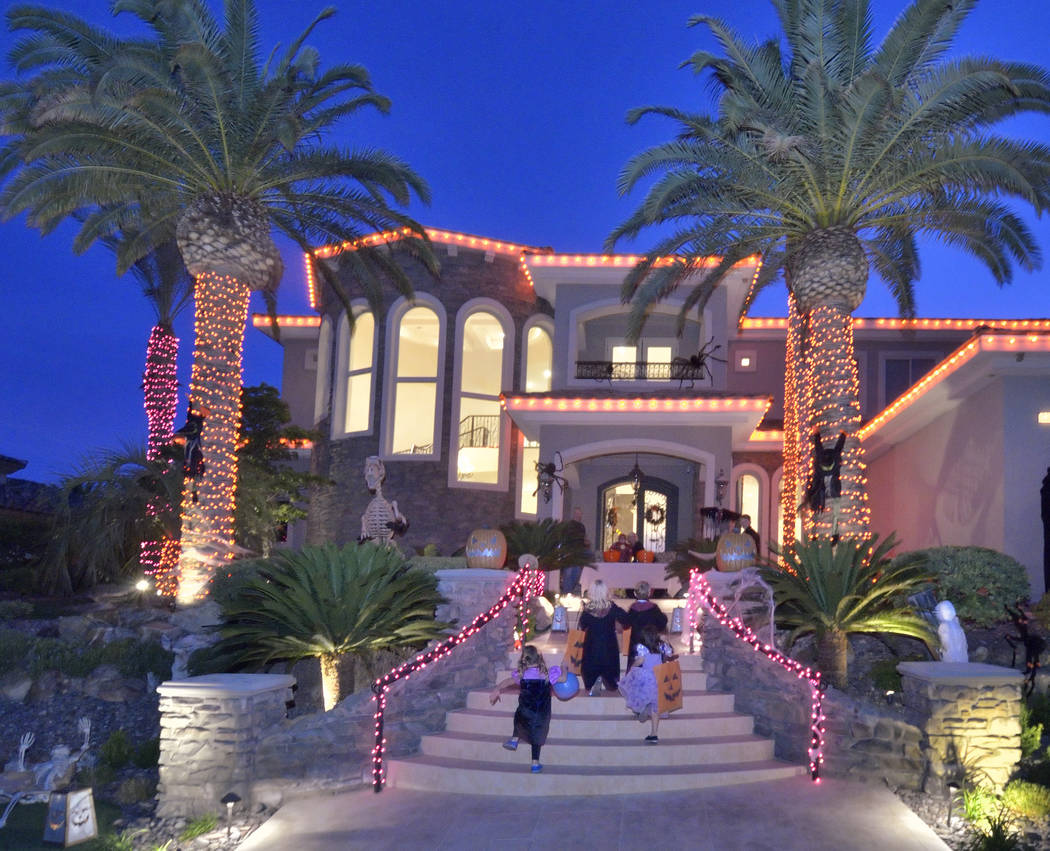 Trick-or-treaters climb the stairs to a Red Rock Country Club home. (Bill Hughes Real Estate Mi ...