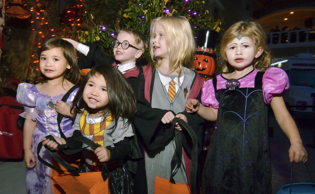 Trick-or-treaters, from left, Sophia and Stella Slade, Colton Sugars, Savannah Rourke and Addis ...