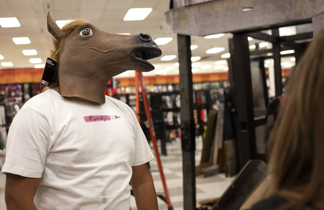 Jonathan Corral of Mesquite goofs off with friends and family while trying on Halloween costume ...
